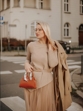 a lady in an asymmetrical hem top and tulle midi skirt